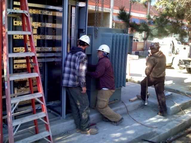 Three construction workers at a building site